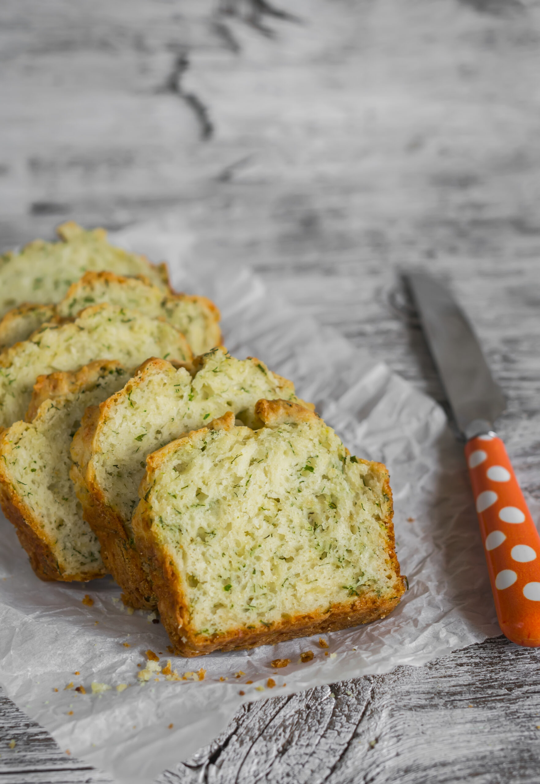 cake with cheese and herbs on a light wooden surface